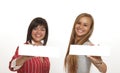 Two women is holding a blank white sign. Royalty Free Stock Photo