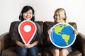 Two woman holding location icon