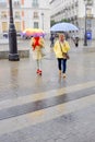 Two women holding umbrellas during heavy rain from Storm Aline in Madrid Spain