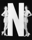 Two women with huge letter N