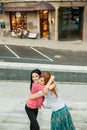 Two women hugging in the street