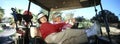 Two Women Laughing In Golf Cart