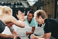 Two women laughing and high fiving during a planking class Royalty Free Stock Photo