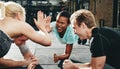 Two women laughing and high fiving during a planking class