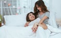 Two women laying down on bed and holding hands. LGBT Concept Royalty Free Stock Photo