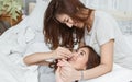 Two women laying down on bed and holding hands. LGBT Concept Royalty Free Stock Photo