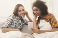 Two women listening music and sharing earphones Royalty Free Stock Photo