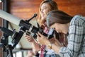 Two woman looking through telescope Royalty Free Stock Photo