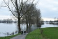 Two women looking at high water in river Rhine