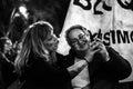 Two women looking at a phone during International Women Day 8 March demonstration in Madrid