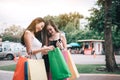 Two women are looking at a shopping bag Royalty Free Stock Photo