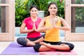 Two women in lotus position during yoga practice Royalty Free Stock Photo