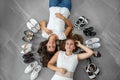 Two women are lying on the floor. Lots of women`s shoes. Top view Royalty Free Stock Photo