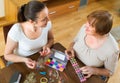 Two women make bracelets at home Royalty Free Stock Photo