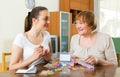 Two women make bracelets at home Royalty Free Stock Photo