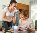 Two women make bracelets at home Royalty Free Stock Photo