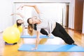 Two women making a fitness exercisen in synchrony