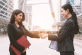 Two women making handshake greeting each other in group meeting at outdoors. Business people and deal contract. Friendship and Royalty Free Stock Photo