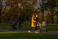 Two women and a man with masks with baby carriages in prague