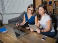 Two women managers preparing to conference using net-book and touch pad Royalty Free Stock Photo