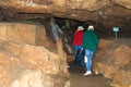 Two women, members of the tourist group, pose against the backdrop of the cave. Red Cave