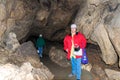 Two women, members of the tourist group, pose against the backdrop of the cave. Red Cave