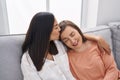 Two women mother and daughter sitting on sofa together at home Royalty Free Stock Photo