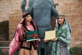 Two women in national clothes holding sprouts of spring wheat grass semeni