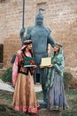 Two women in national clothes holding sprouts of spring wheat grass semeni