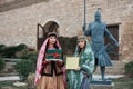 Two women in national clothes holding sprouts of spring wheat grass semeni