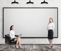 Two women near whiteboard