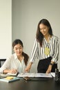 Two women office workers working in office and discussing some paperwork. Royalty Free Stock Photo