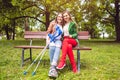 Two women, one healthy and one with a sprained foot, on a bench