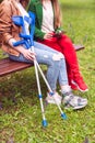 Two women, one healthy and one with a sprained foot, on a bench