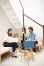 Two women and one man businessmen working informally on their computers in their office chairs Royalty Free Stock Photo