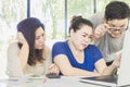 Two women and one man is seriously working together Royalty Free Stock Photo