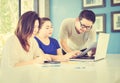 Two women and one man are working with at computer in modern office Royalty Free Stock Photo