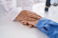 Two women pharmacist and customer with hands together at pharmacy Royalty Free Stock Photo