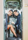 Two women pilots smiles and wishes a successful flight. Trainee Pilot and Flight Instructor in an Aircraft Cockpit. she Royalty Free Stock Photo