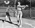 Two women playing baseball