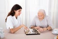 Two Women Playing Checkers Game Royalty Free Stock Photo