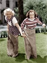 Two women playing a game of potato sack racing