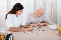 Two Women Playing Jigsaw Puzzle Royalty Free Stock Photo