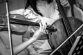 Two women playing violin and cello in a chamber orchestra shot in black and white