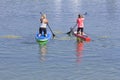 Two women practicing paddle board