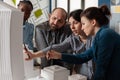 Two women professional architects explaining construction model design to team colleagues Royalty Free Stock Photo