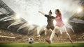 Two women, professional football, soccer players in motion during match, game at 3d open air stadium arena with blurred Royalty Free Stock Photo