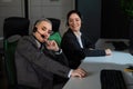 Two women in protective masks are bored at work. Call center operators at the desk Royalty Free Stock Photo