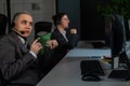 Two women in protective masks are bored at work. Call center operators at the desk Royalty Free Stock Photo