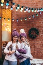 Two women in purple knitted hats